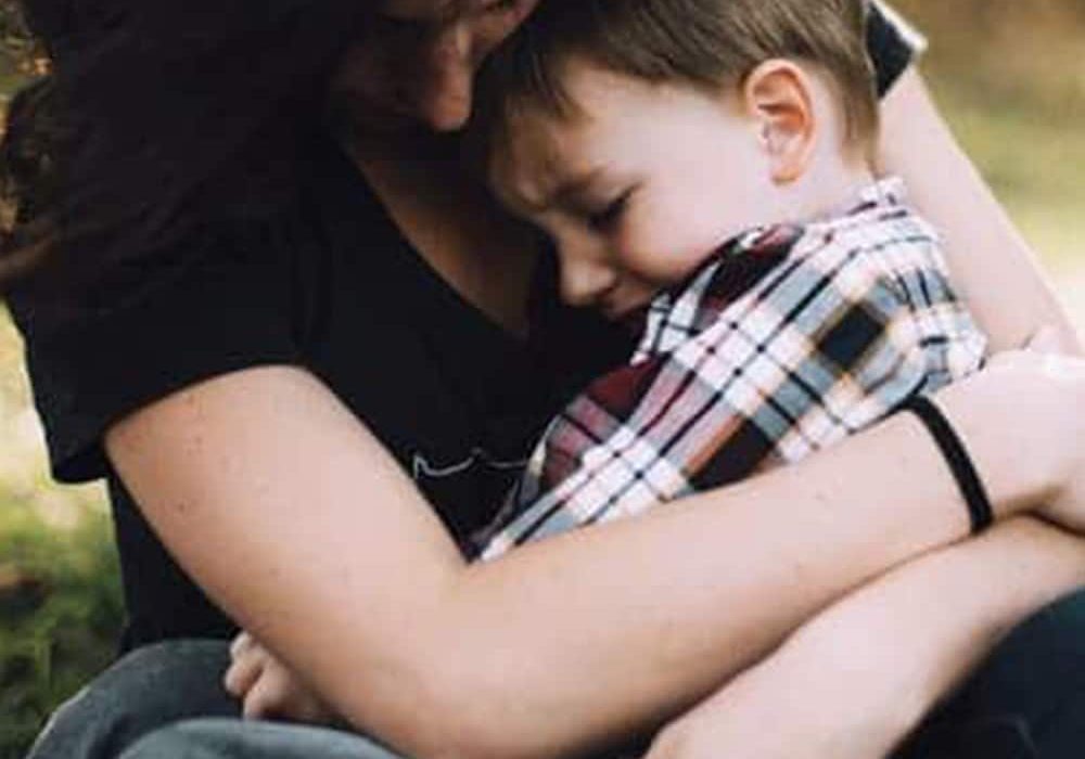 Mother Cuddling Her Son — McVittie Legal In Alstonville, NSW